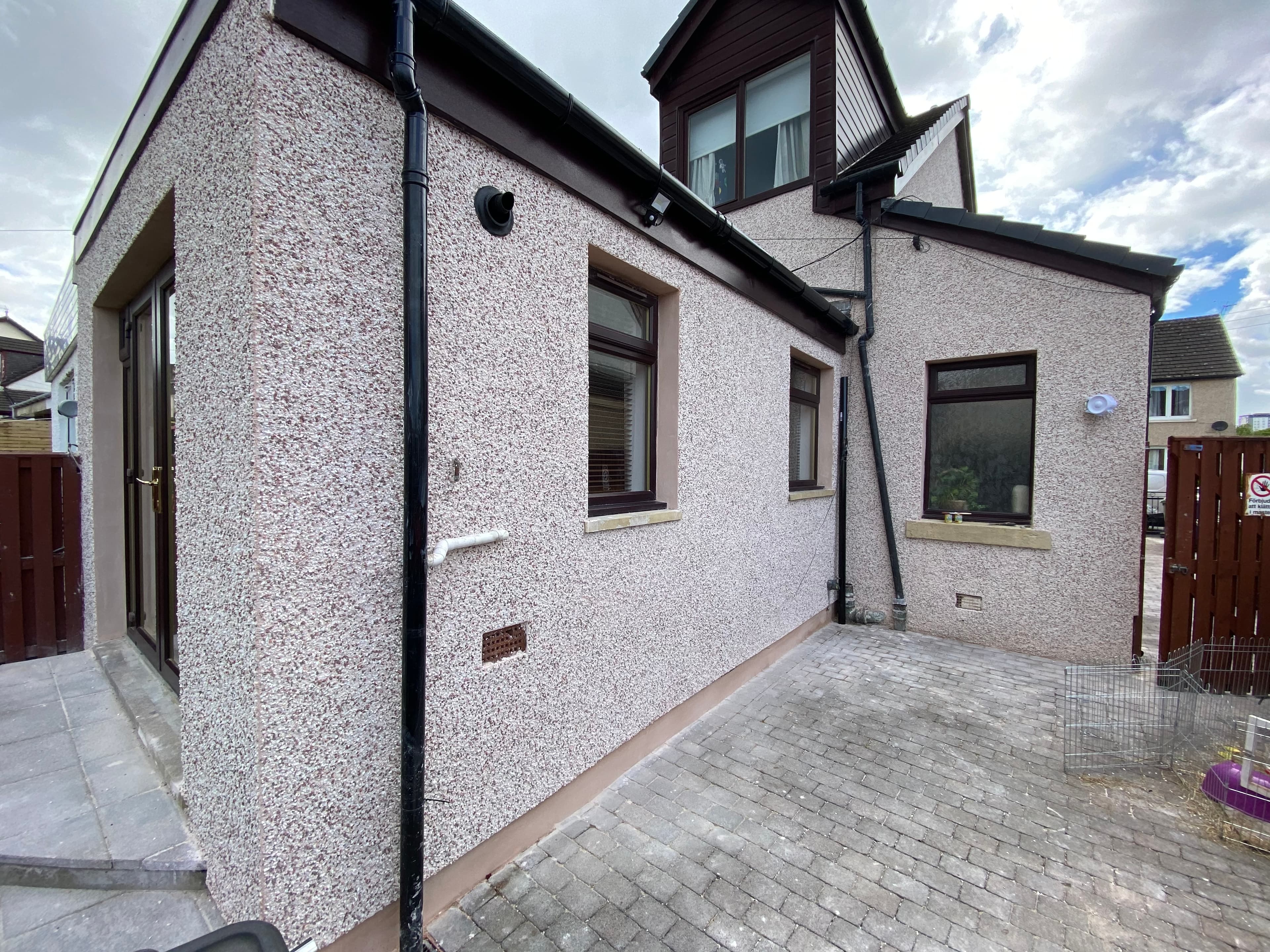 Scratch and lime render on a house elevation